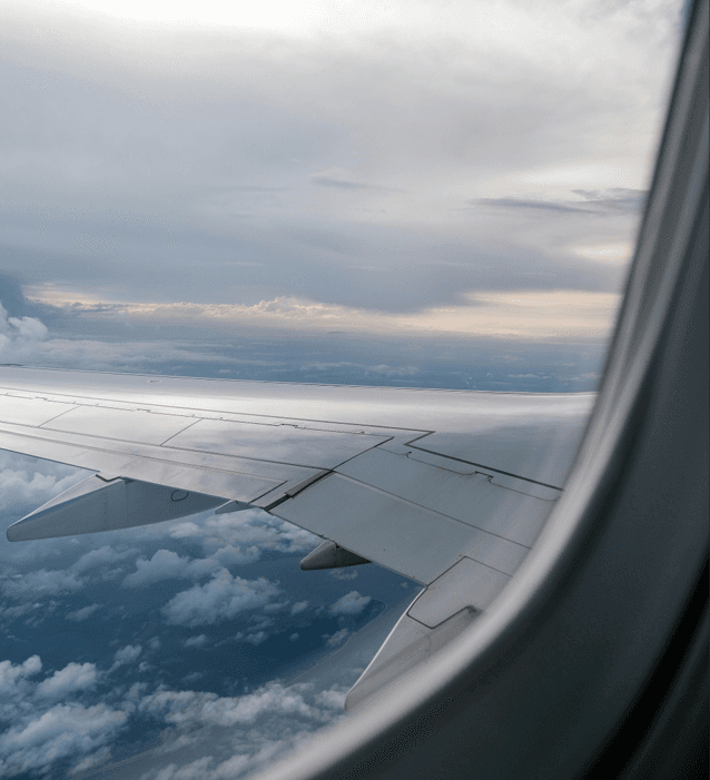 Sunset In-Flight Wing View Above the Clouds