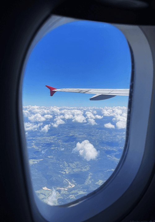 Flight Above the Clouds — Jetliner Wing Window View
